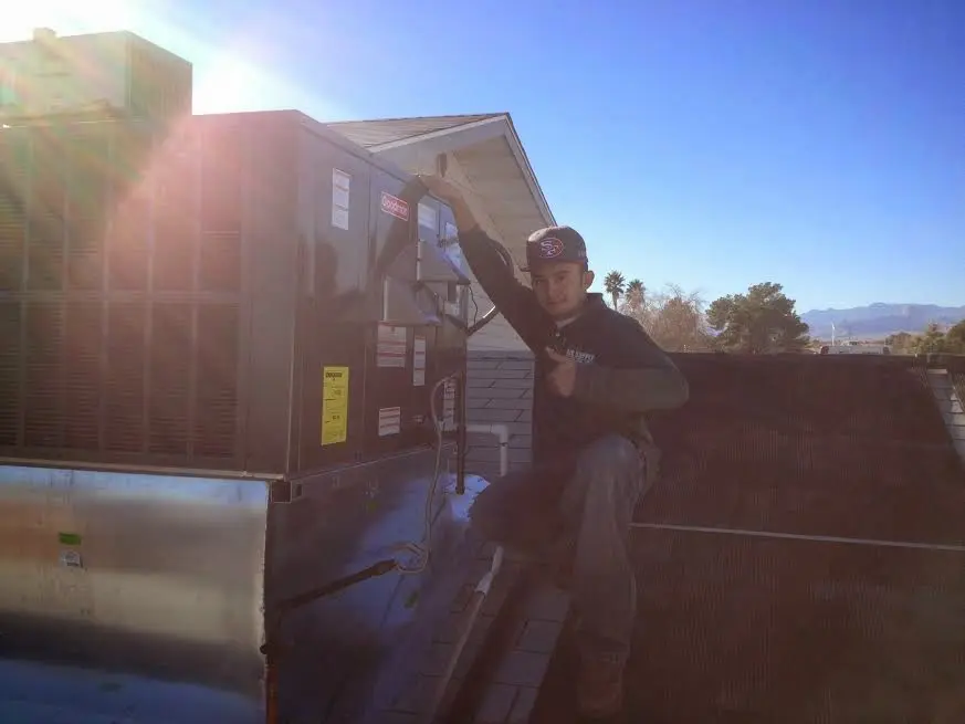 HVAC technician performing HVAC Inspection on a rooftop unit in Glen Carbon